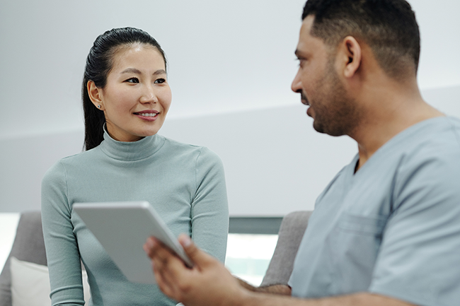 man and woman with ipad sharing information