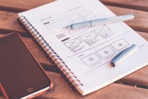notebook with a mockup of a webpage