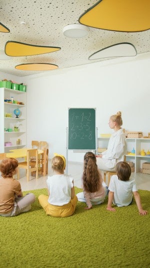 teacher showing students math problem