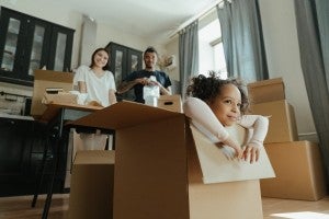 family moving with boxes on floor