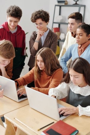 teacher working with student group