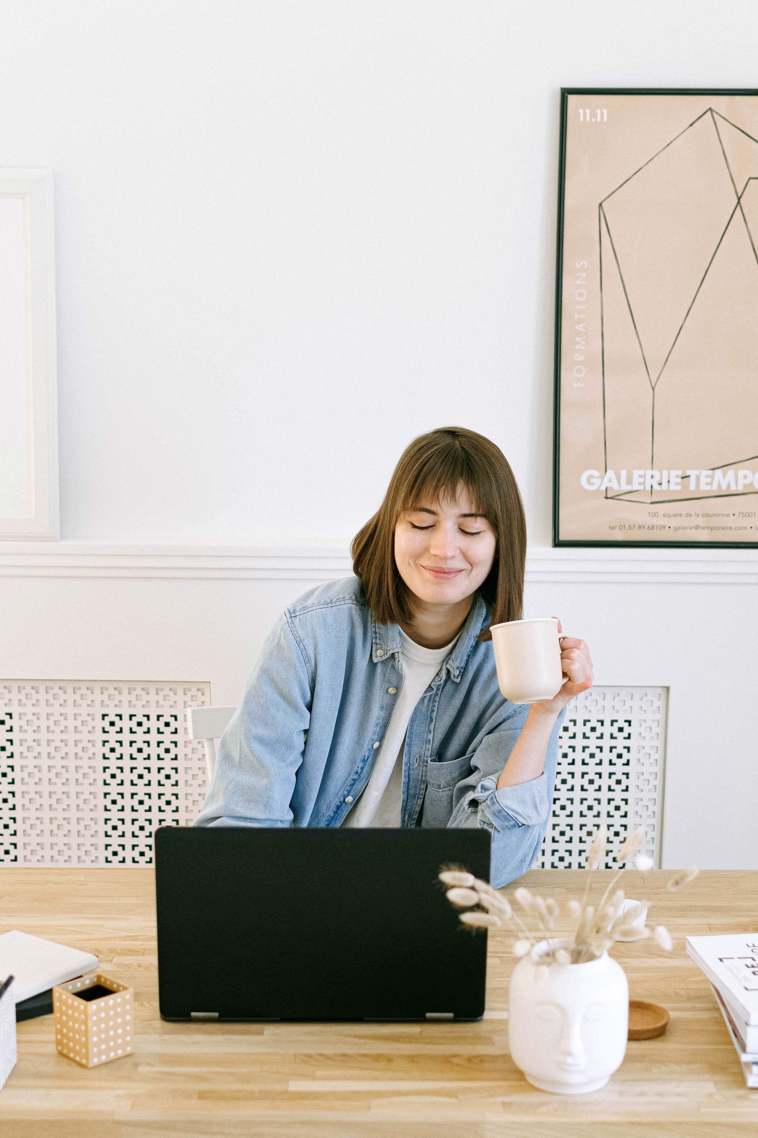 woman smiling while working on a laptop