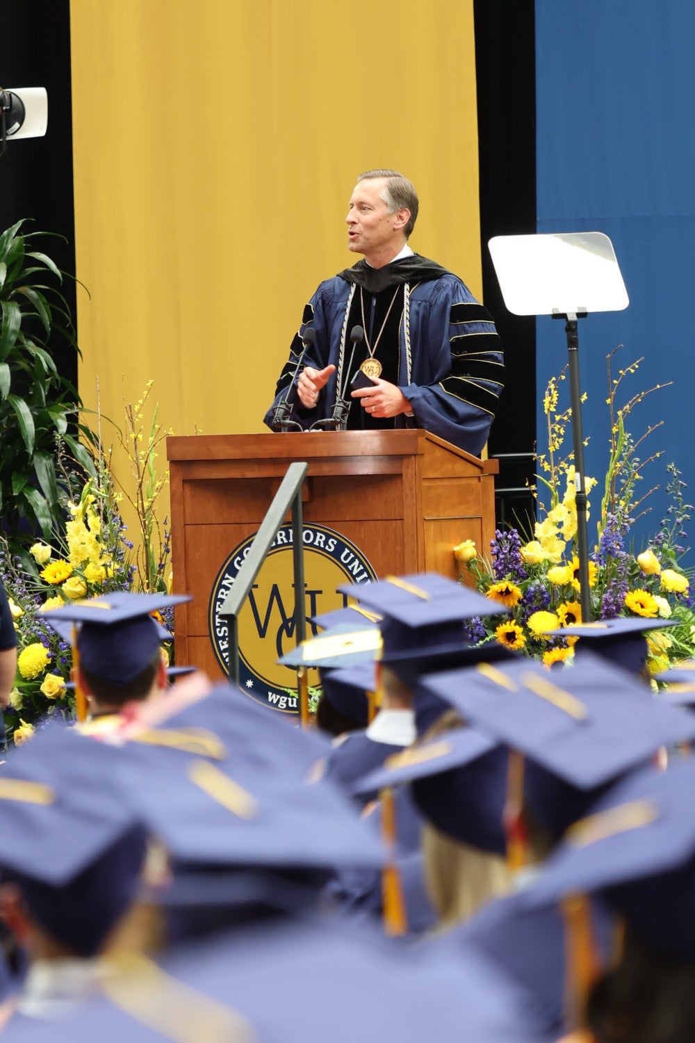 WGU President Scott Pulsipher speaking at the podium at graduation
