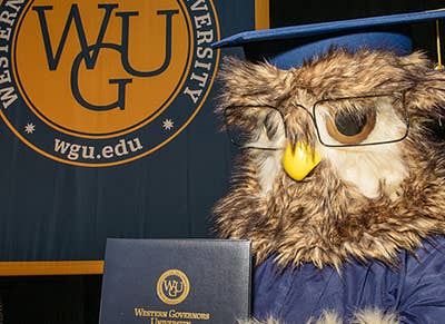 Sage the Owl mascot posing with WGU diploma