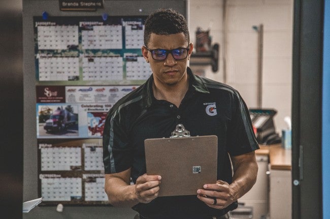 male manager looking at clipboard