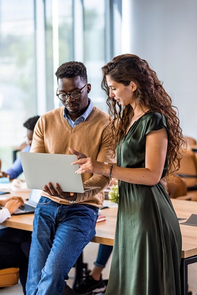 Man and woman looking at a laptop