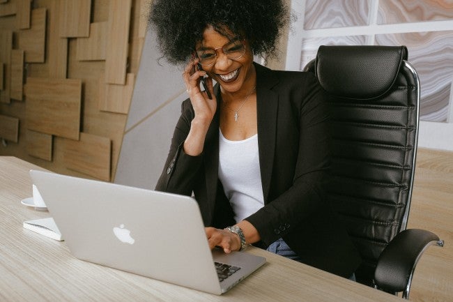 Woman on phone at computer
