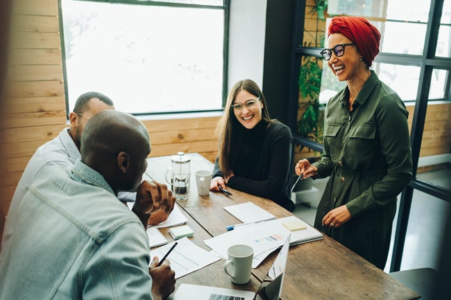 Group of men and women coworkers in their mid 30s and 40s having a friendly meeting