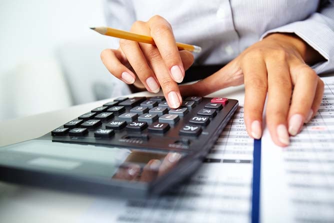accountant typing on a calculator