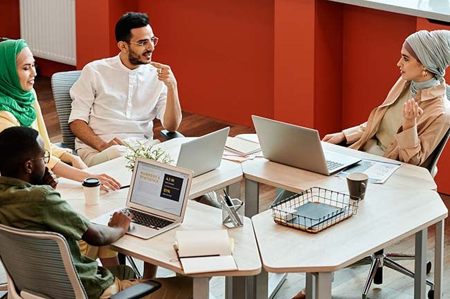 Group of people at table with computers