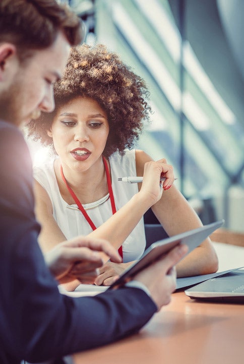 Man and woman looking at a tablet
