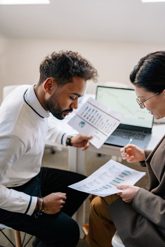 Two individuals looking at paperwork