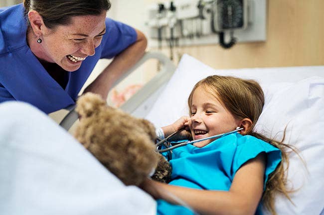 Nursing laughing with a young patient