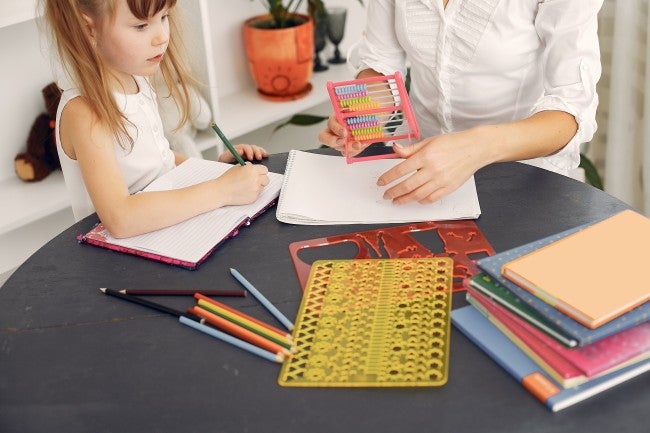 Teacher helping young student with math