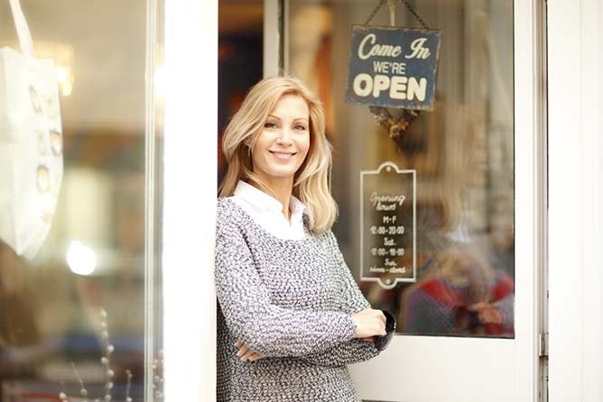 Women standing in store front entrance 