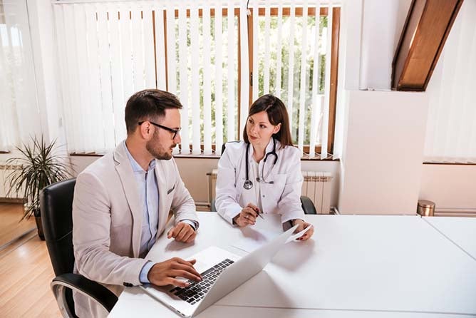 Female doctor discussing with manager..