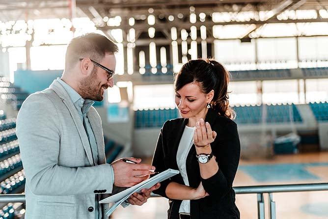 Two business professionals discussing a contract