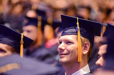 Graduate watching commencement ceremony