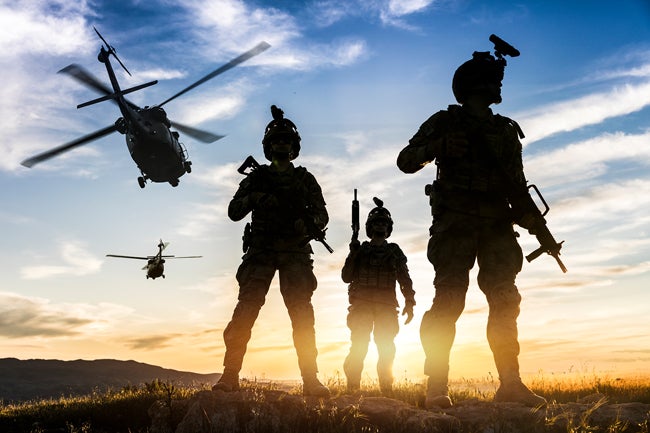 Shot of air and space force members being backlit by the sunset