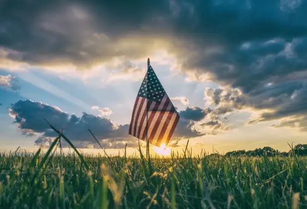 View of small American flag in the dawn outside