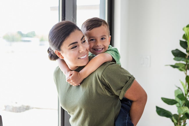 Female military member hugging their child