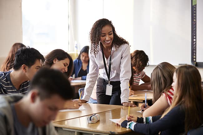 Women teacher teaching a group of teenagers