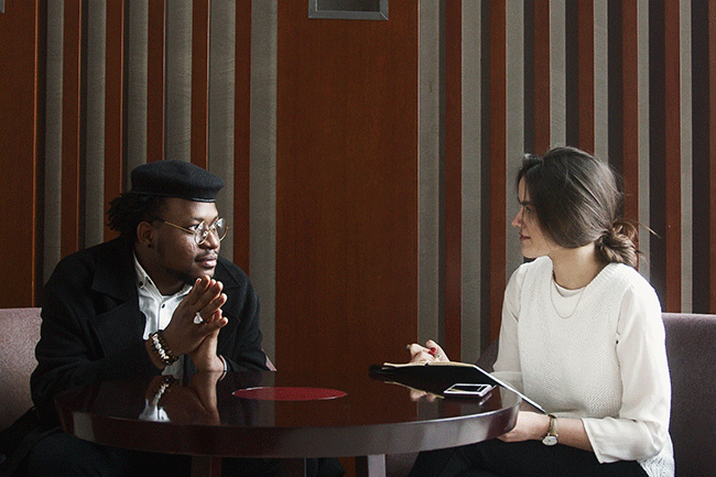 two people meeting around a table drinking coffee