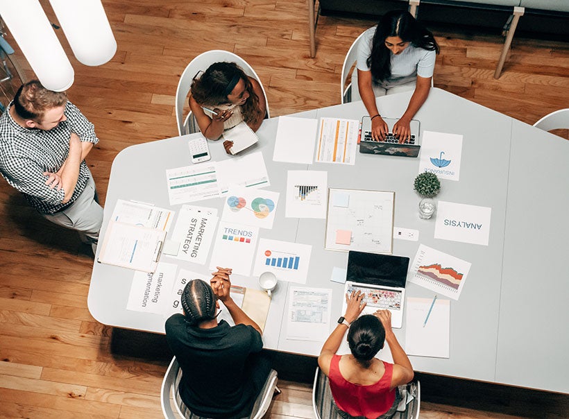 Group of employees having a discussion during a meeting seen from above