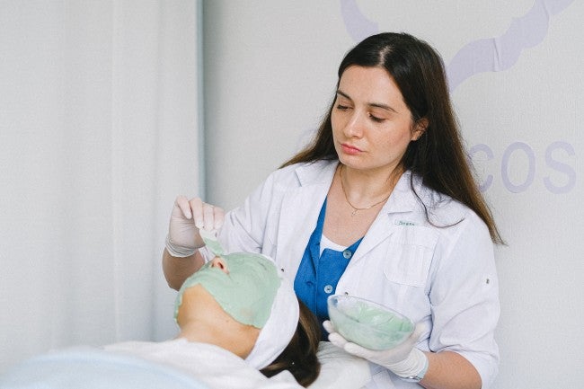 a women giving someone a facial at a spa