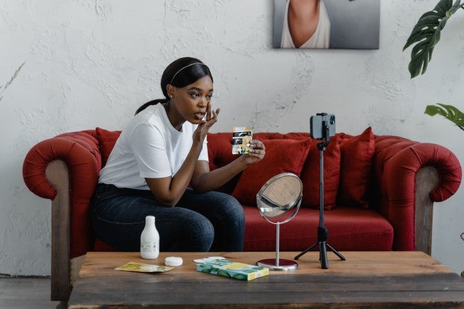 girl talking to her phone reviewing a product