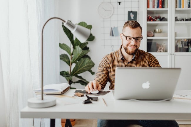 man studying at a laptop