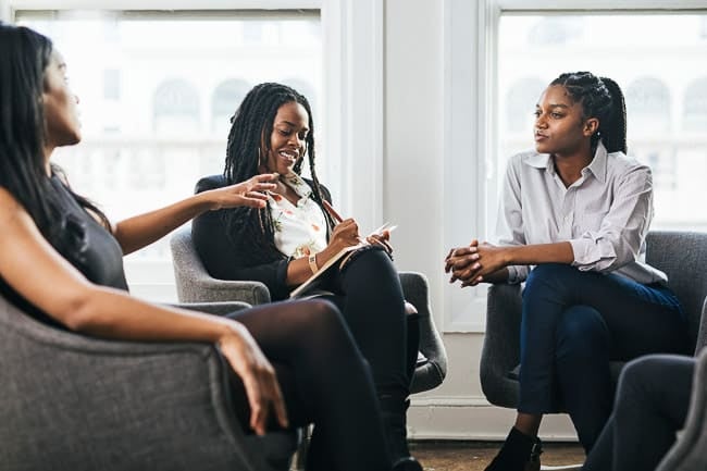 3 women talking in a circle