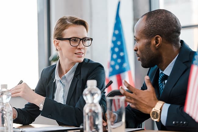 man and women talking at a meeting 