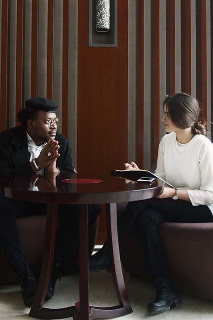 two people talking around a table 