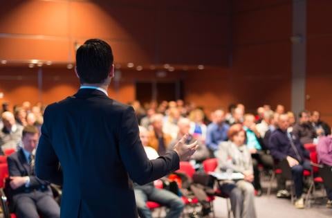business man talking to a crowd