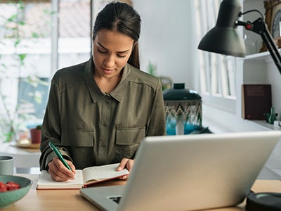 Women studying for achool at her laptop