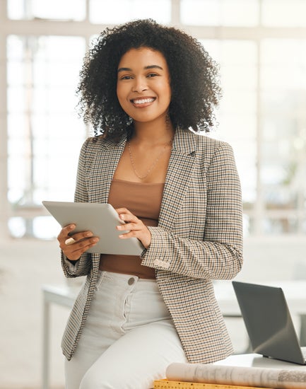 Woman holding a tablet and smiling