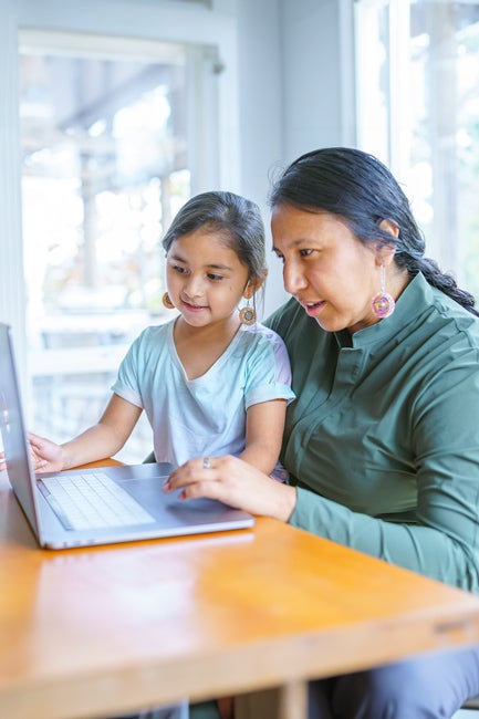 Mother and child looking at laptop screen