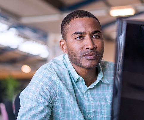 male IT professional looking at the computer monitor