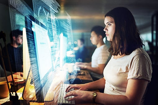 Shot of a programmer working on a computer code at night