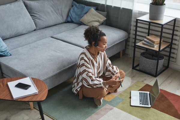 Young woman on a laptop studying in her living room