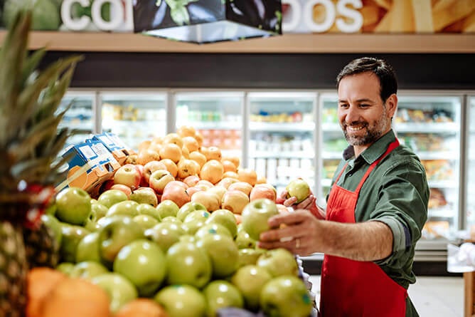 Grocery store owner restoking food