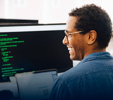 Male IT professional looking at code on his computer