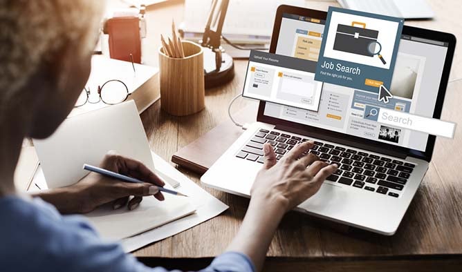 View of a person searching on their laptop for job postings