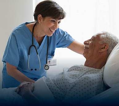 Nurse talking with a patient in hospital room