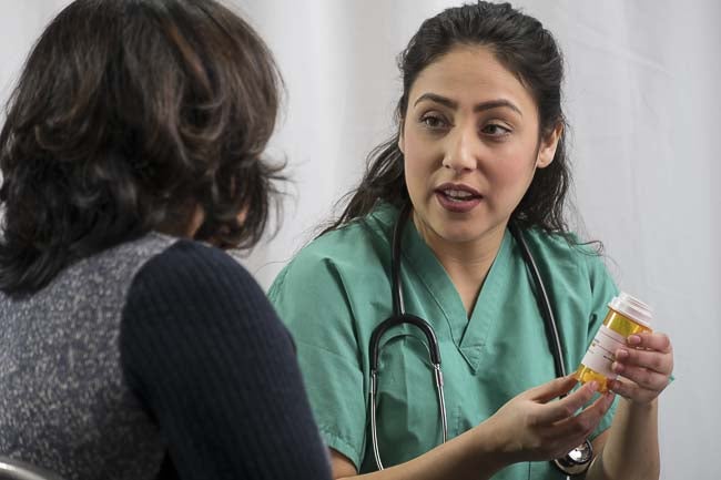 nurse showing meds to a patient