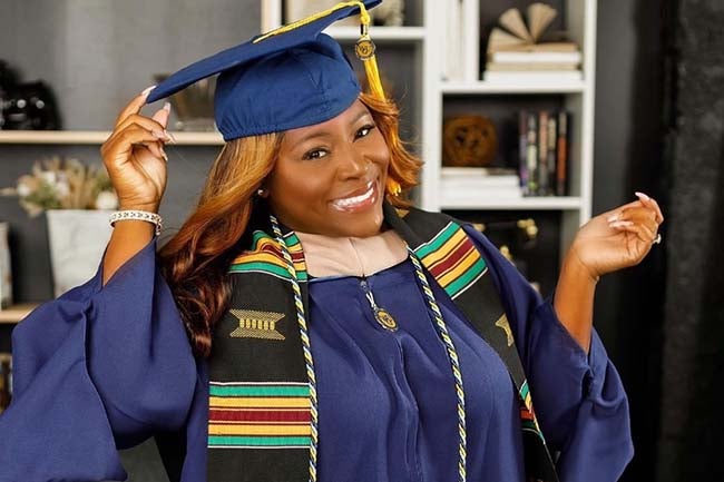 Qu'Teaus wearing graduation cap and gown