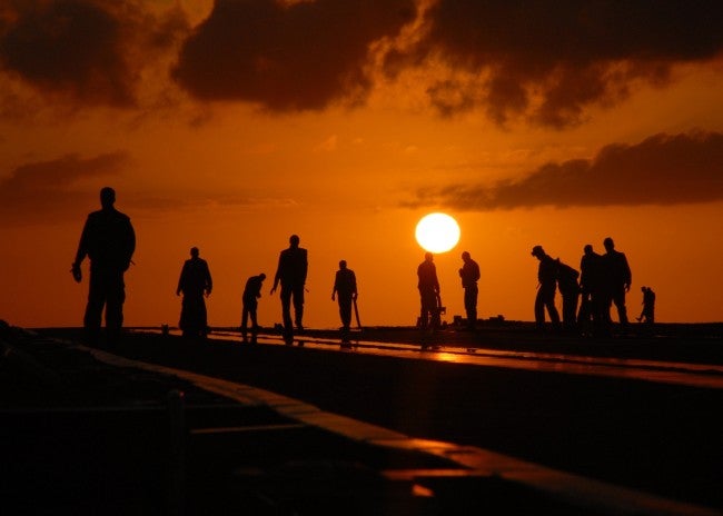 Military personell shadows in sunset