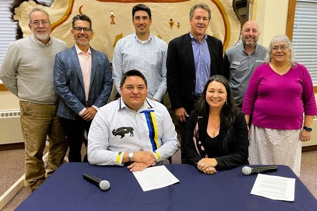 Leaders gather for the ceremonial signing of the WGU-BFCC partnership, including (front row, l. to r.) BFCC President Dr. Brad Hall, WGU Regional Vice President Dr. Tonya Drake, and (back row, third from right) former Montana Governor Steve Bullock.