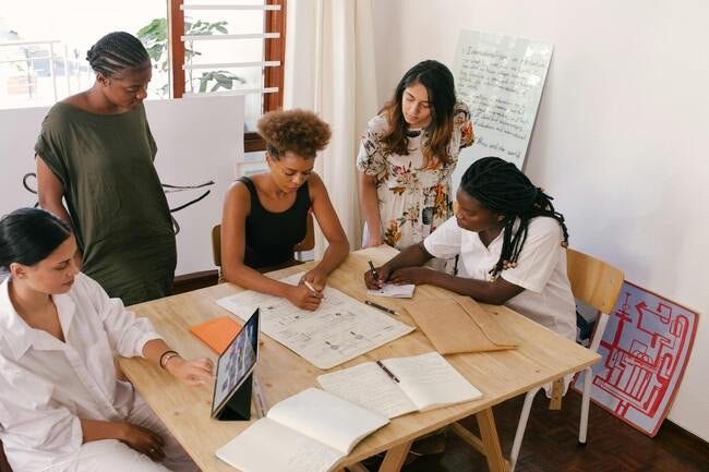 Group of women working at a computer